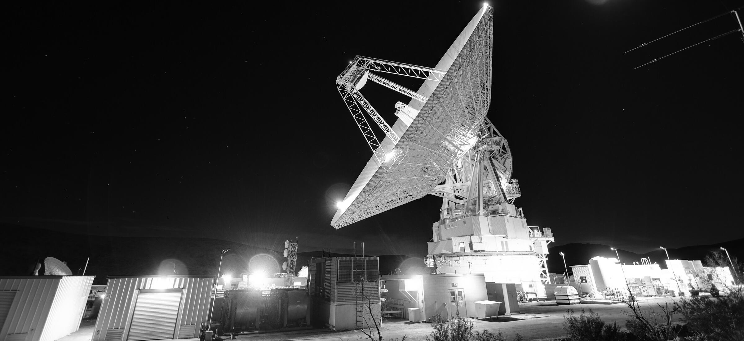 The 70-metre Deep Space Station 14 antenna at Goldstone, lit at night