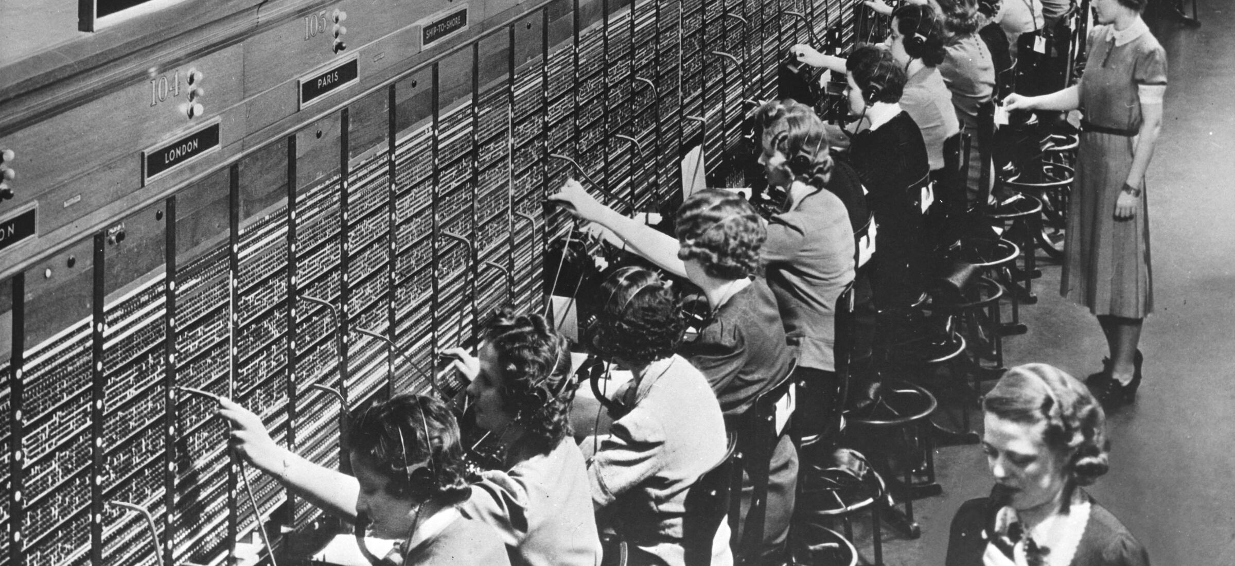 Operators at a Bell System international telephone switchboard with London and Paris route positions